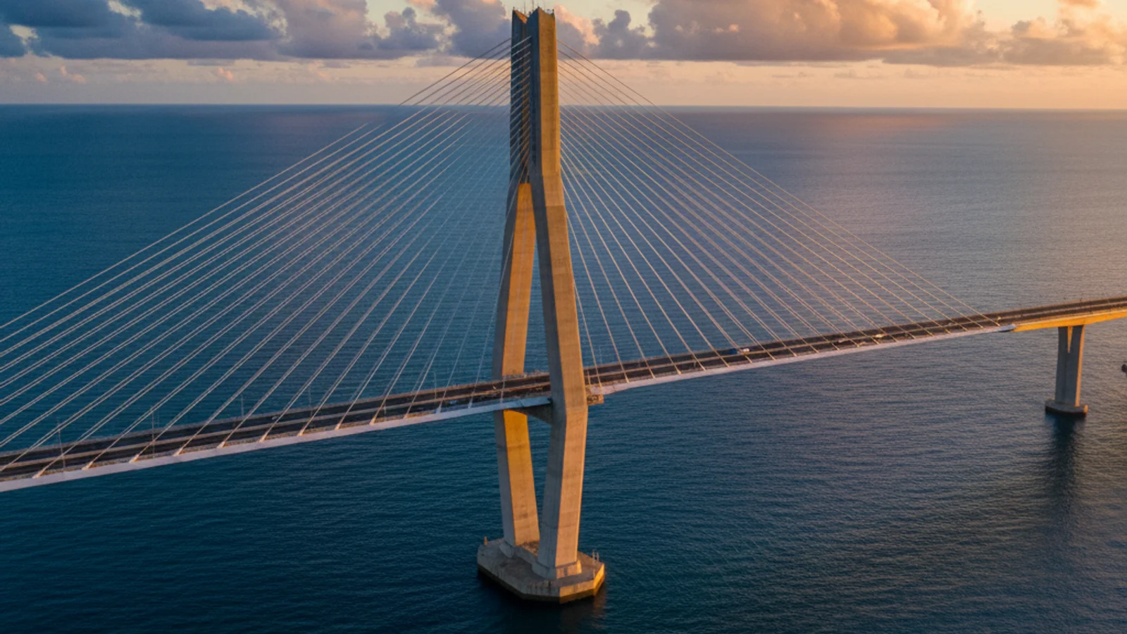 Cheongna Sky Bridge — towering cable-stayed sea bridge main tower over blue ocean at golden hour — KoreaHacks